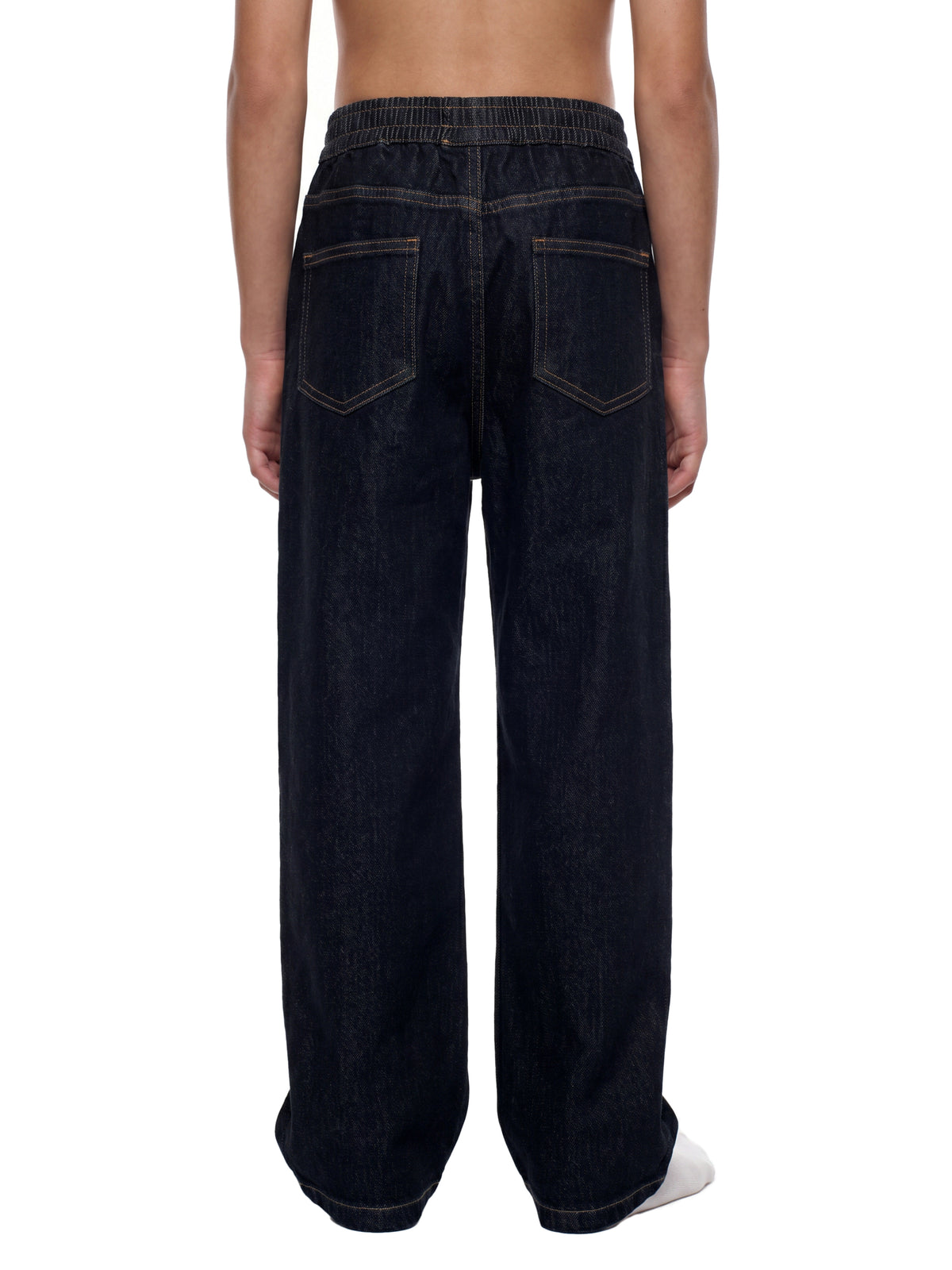Rear view of a person wearing dark indigo wide-leg jeans with contrast stitching and an elastic waistband, shown against a plain white background.