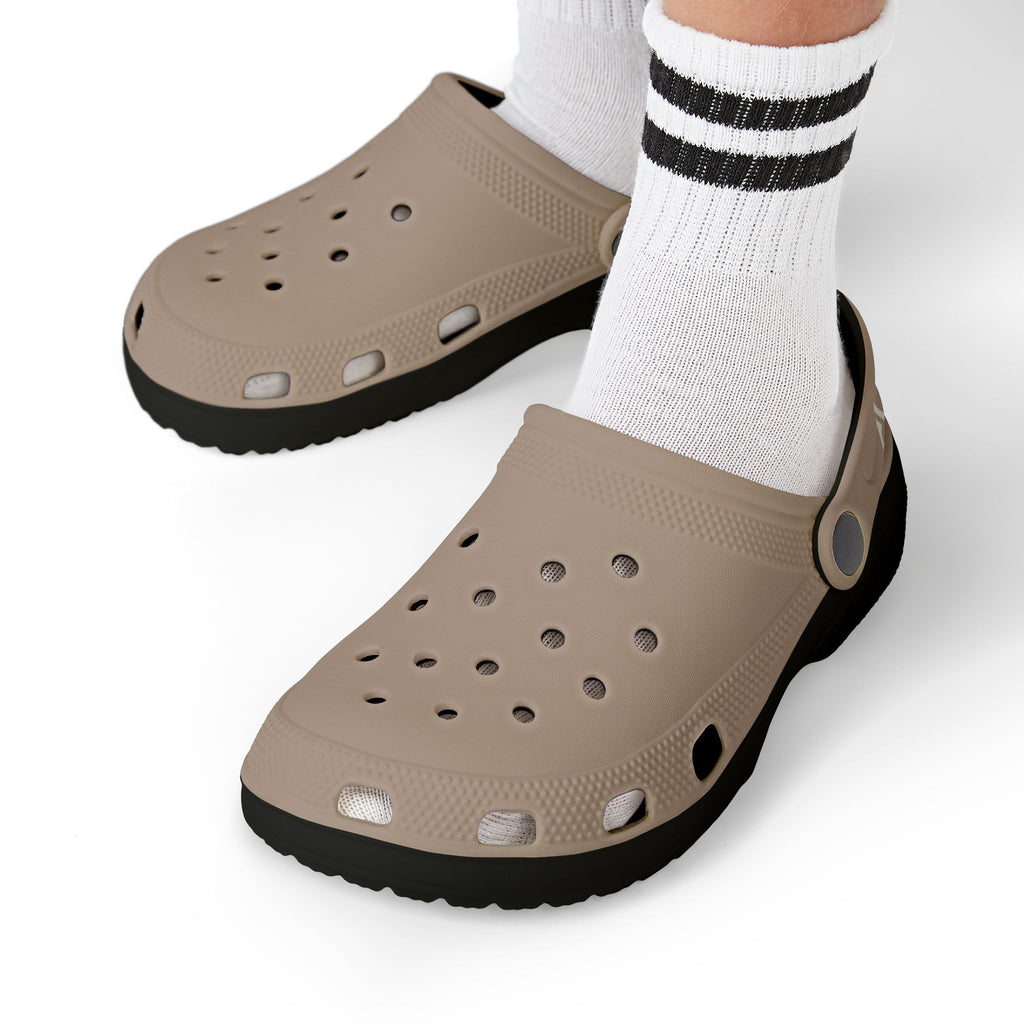 Clogs with fish pattern worn with white socks on a white background