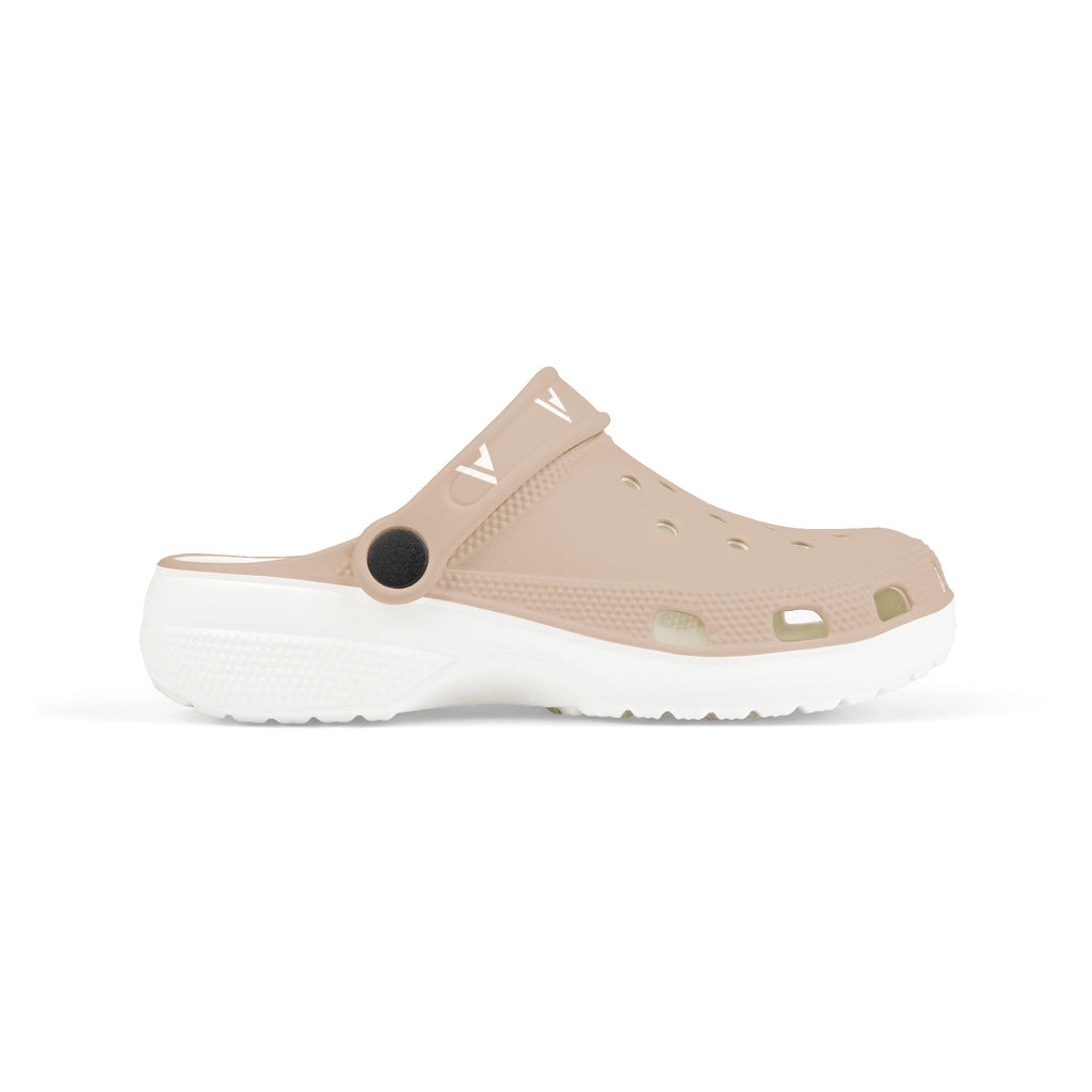 A single beige clog-style sandal with a white sole, shown in a side profile on a clean white background. The upper features multiple ventilation holes, a black circular accent near the heel, and a small white logo printed on the strap.