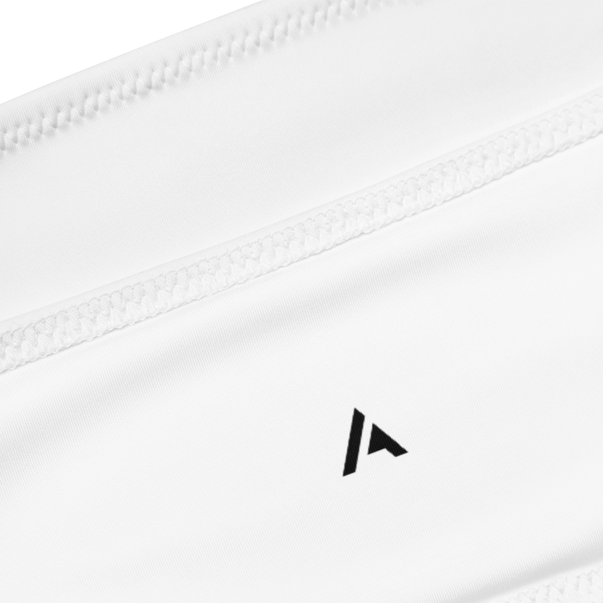 Product close-up of a white bandeau bikini top with our black logo